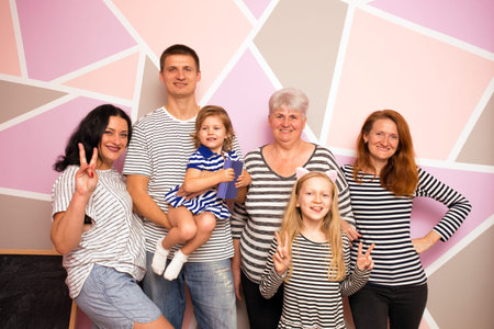 big happy family. mother with daughter, son and granddaughters on a bright background