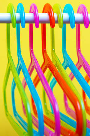 multicolored hangers on yellow background with small depth of fieldの写真素材