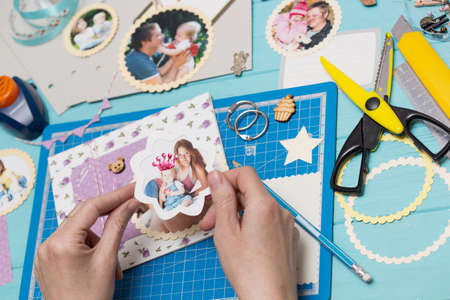 scrapbook background. the process of creating a childrens album. Card and tools with decorationの写真素材