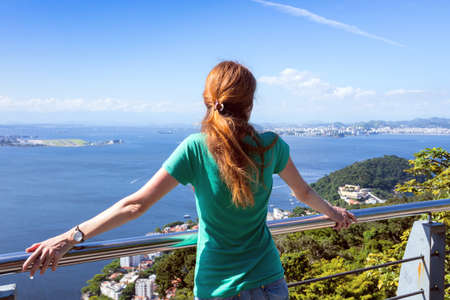 girl tourist looking on the Rio de Janeiro. view from Pao de Acucar. Brazilの写真素材