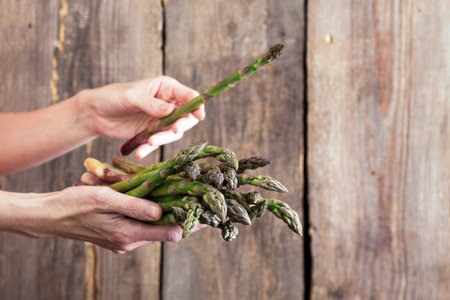 girl holding asparagus in her hands. veganism and raw foodsの写真素材