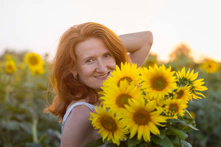 happy girl in a field of sunflowers at sunset. Ukraineの写真素材