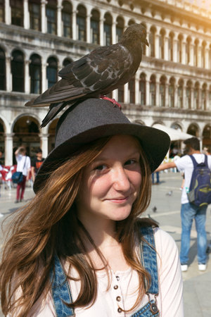 Girl teenager with dove on Piazza San Marco, venice. Italyのeditorial素材