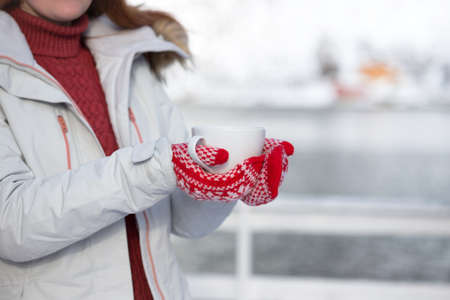 winter. girl with a cup on the background of rorbu on the Lofoten islands. Norwayの写真素材
