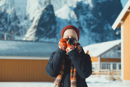 girl travels around lofoten islands and takes pictures on camera. Norwayの写真素材