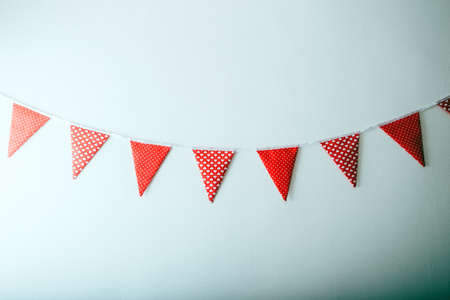 colorful party flags made of paper on a white backgroundの写真素材