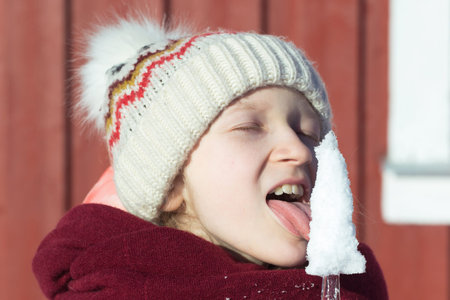 winter. little norwegian girl with an ice floe in hand. Norway