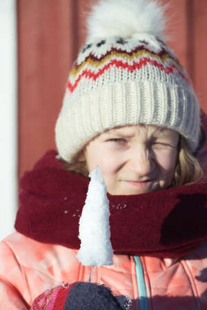winter. little norwegian girl with an ice floe in hand. Norwayの写真素材