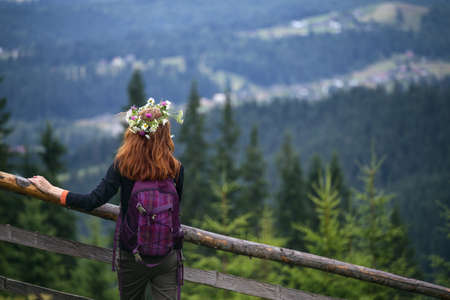 girl in a wreath of wildflowers in the mountains. Carpathiansの写真素材