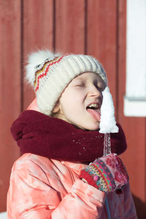 winter. little norwegian girl with an ice floe in hand. Norwayの写真素材