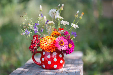 beautiful bright bouquet of wildflowers in a vase in the gardenの写真素材