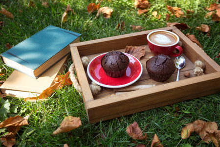cup of coffee with chocolate Muffins on grass. fall and relax