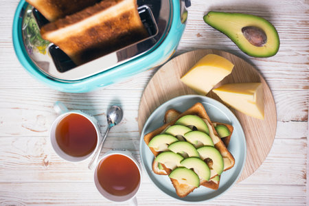 bright, fun breakfast. cyan color toaster on a wooden backgroundの写真素材
