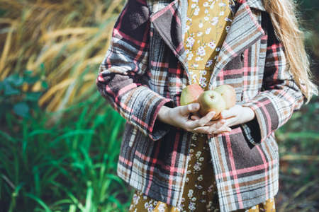 autumn - beautiful girl with pears in hands in the gardenの写真素材