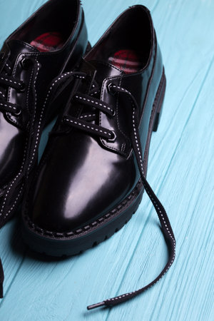 stylish black shoes on a blue background. fashion trends. beautiful female shoes