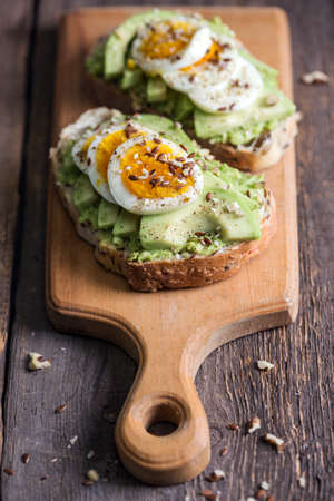 healthy nutrition and light breakfast - toast with avocado and eggの写真素材