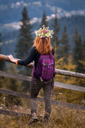 girl in a wreath of wildflowers in the mountains.の写真素材