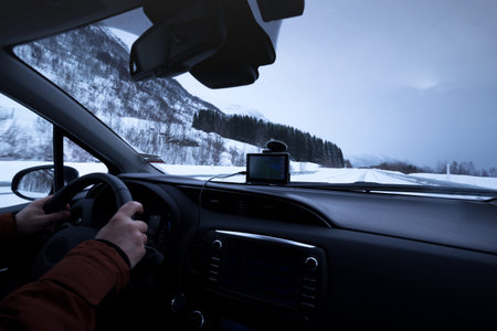 roadtrip - man hands on the wheel and norwegian mountains.  Lofoten Islands. Norway.