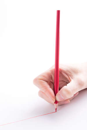 hand with the red pencil on a white background
の写真素材