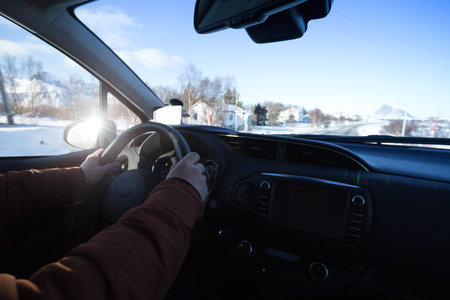 roadtrip - man hands on the wheel and norwegian mountains.  Lofoten Islands. Norway. 