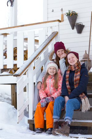 happy family on the porch of the house on the background traditional norwegian wooden house. ...