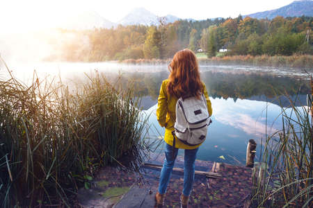girl stands on the beautiful mountain lake. autumn
の写真素材