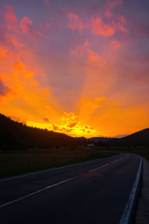 Summer Road Trip. beautiful landscape and view of a mountain road at sunset time. Romania.の写真素材