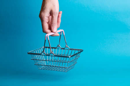 Prices for shopping consumer basket products. empty basket on a blue backgroundの写真素材