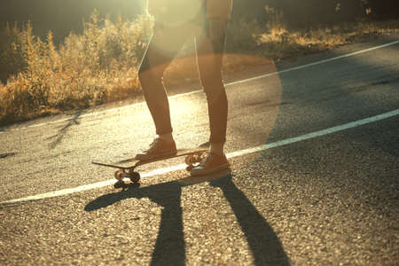 feet on a skateboard. girl rides on a skateboard at the transalpine. Romania.の写真素材