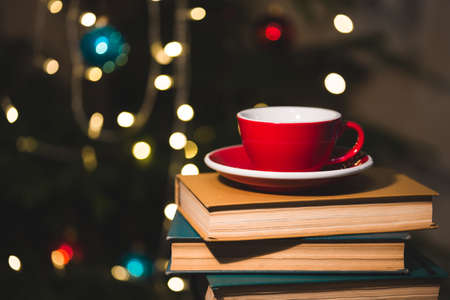 books and red cup of coffee with  croissant on Christmas  backgroundの写真素材