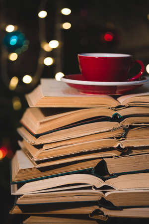 books and red cup of coffee with  croissant on Christmas  backgroundの写真素材