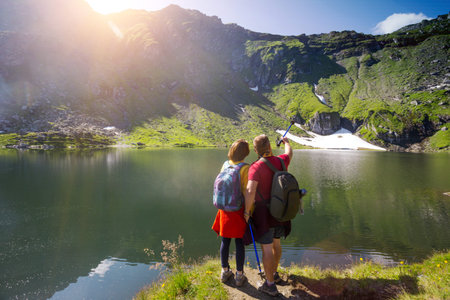 girl hiker with dad on a trail in the mountains. Transfogaras. Romania