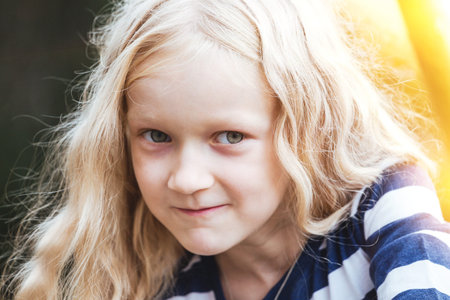 Portrait of a smiling beautiful little blonde girl.