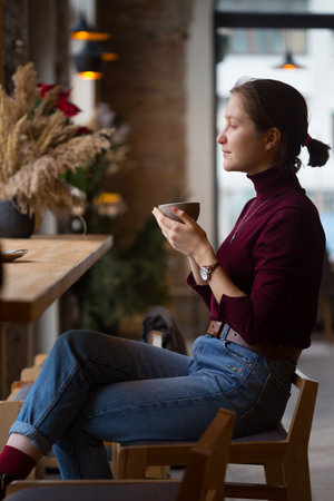 breakfast - girl sitting with  cup of coffee at the cafe