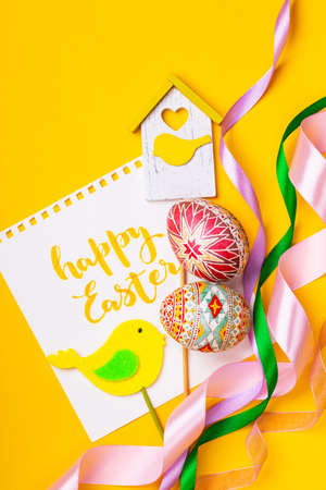 happy easter card. beautiful Easter egg Pysanka handmade - ukrainian traditional on a yellow background
の写真素材