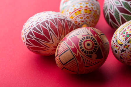 happy easter card. beautiful Easter egg Pysanka handmade - ukrainian traditional on a red backgroundの写真素材
