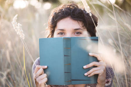 retro style. girl reads a book outdoorsの写真素材