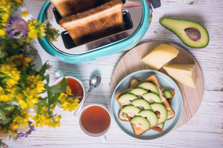 bright, fun breakfast. cyan color toaster on a wooden background