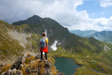 girl hiker on a path at the mountains. Transfogaras. Romania