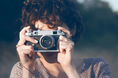 portrait of a beautiful smiling girl with retro camera. Happy lifestyleの写真素材