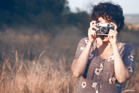 portrait of a beautiful smiling girl with retro camera. Happy lifestyle