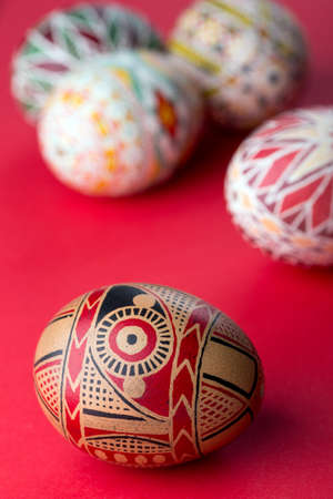 happy easter card. beautiful Easter egg Pysanka handmade - ukrainian traditional on a red backgroundの写真素材