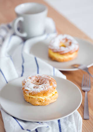 beautiful brewing cake and a cup of tea nearby.の写真素材