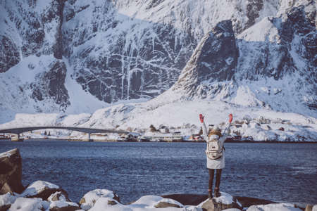 winter. girl walks along the shore of the fjord. Lofoten islands. Norwayの写真素材