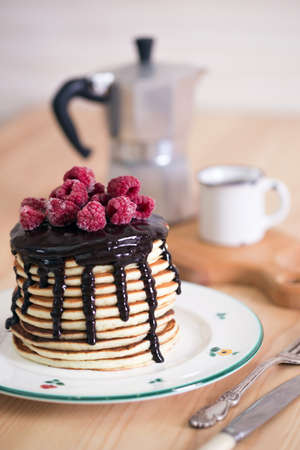 Stack pancakes with chocolate and raspberriesの写真素材