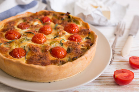 pie with  cheese brie and cherry tomatoes - french cuisine