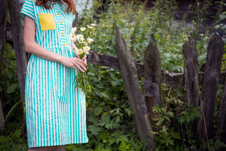 girl holds bouquet of camomile in hands
の写真素材