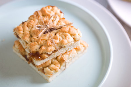 Grated Cake With Jam on a white wooden background