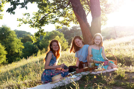 Summer - family on a picnic in a meadow in the forestの写真素材