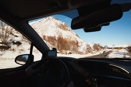 roadtrip - man hands on the wheel and norwegian mountains.  Lofoten Islands. Norway.の写真素材